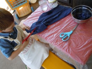 Br cutting up an old T-Shirt into strips for the "mache" bowl